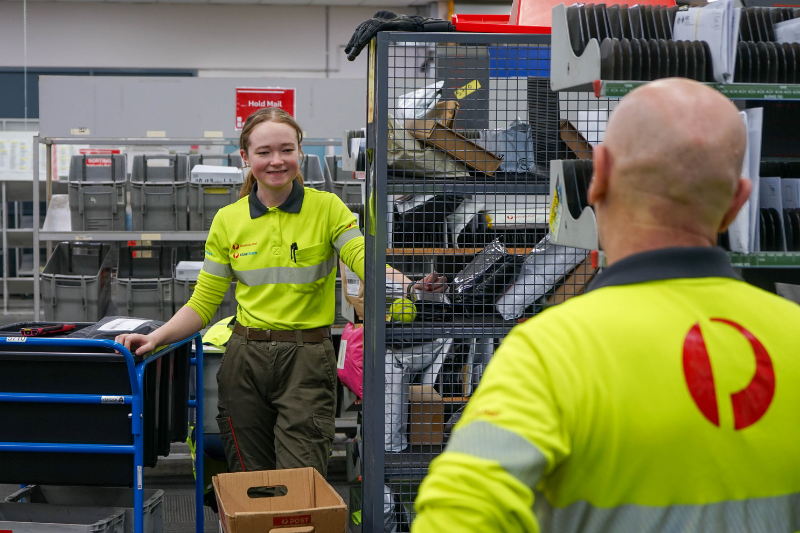 Two team members standing at their sorting frames 