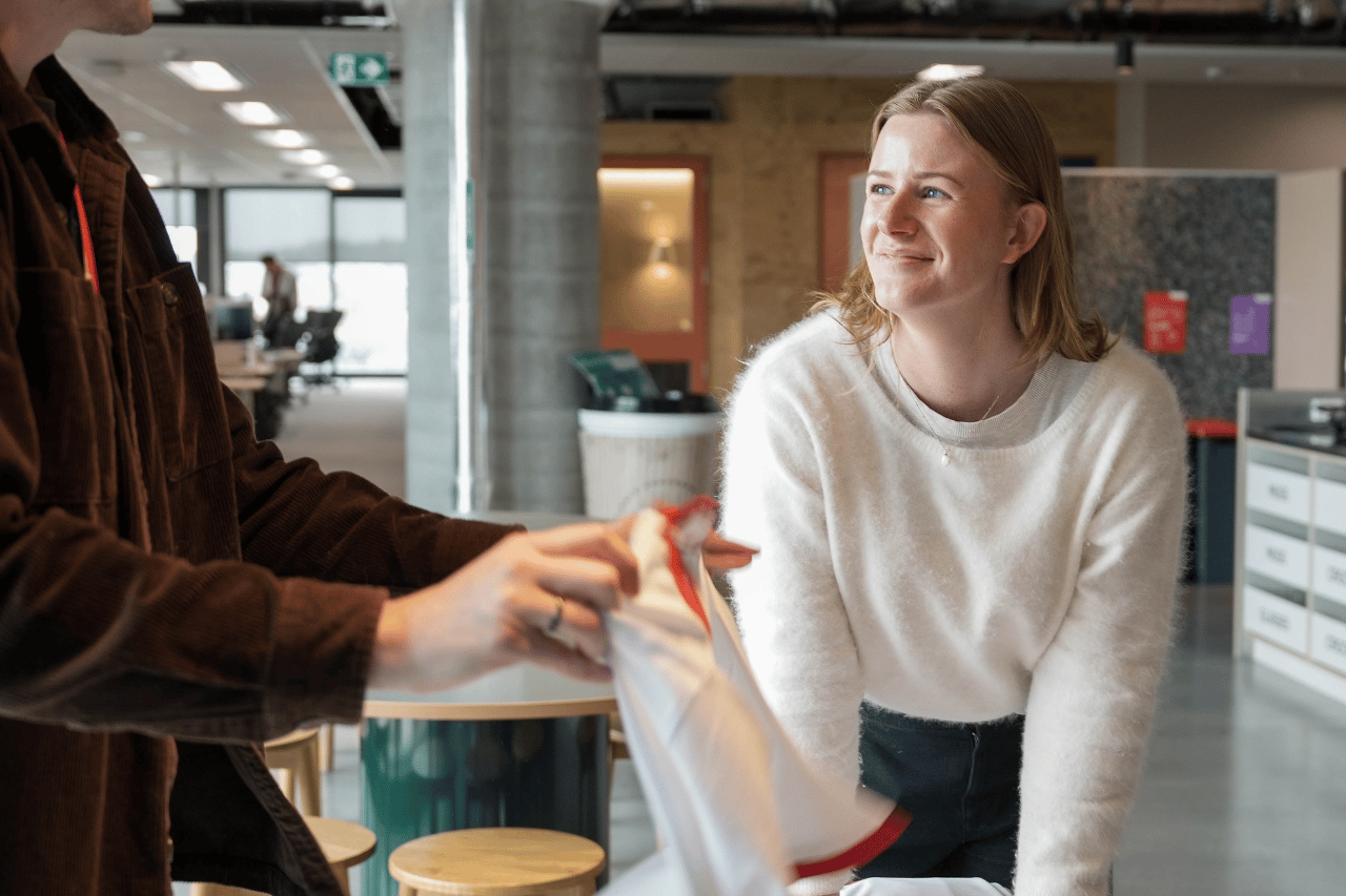 Two team members sorting merchandise in communal space in office