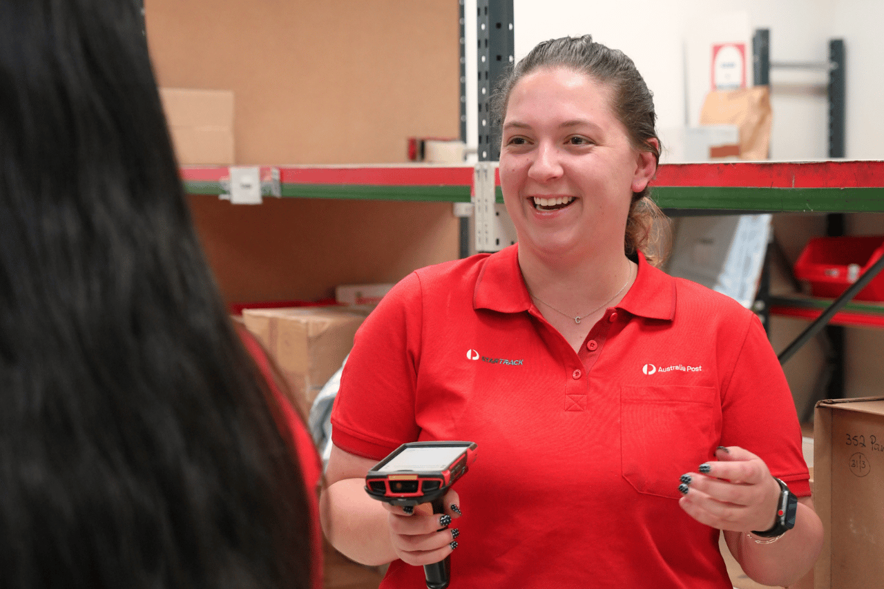 Retail team member talking to colleague in the back of a retail store