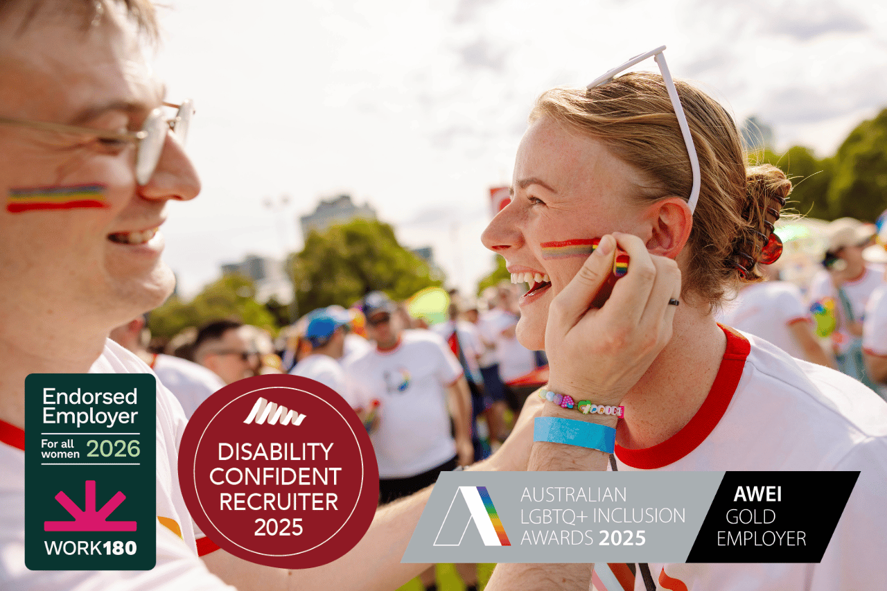 Team member with rainbow face paint helping another team member put on rainbow face paint at Pride March. Overlayed images read ‘Disability confident recruiter 2025’, ‘Australian LGBTQ Inclusion Awards 2025’ and Endorsed Employer Work180 2026