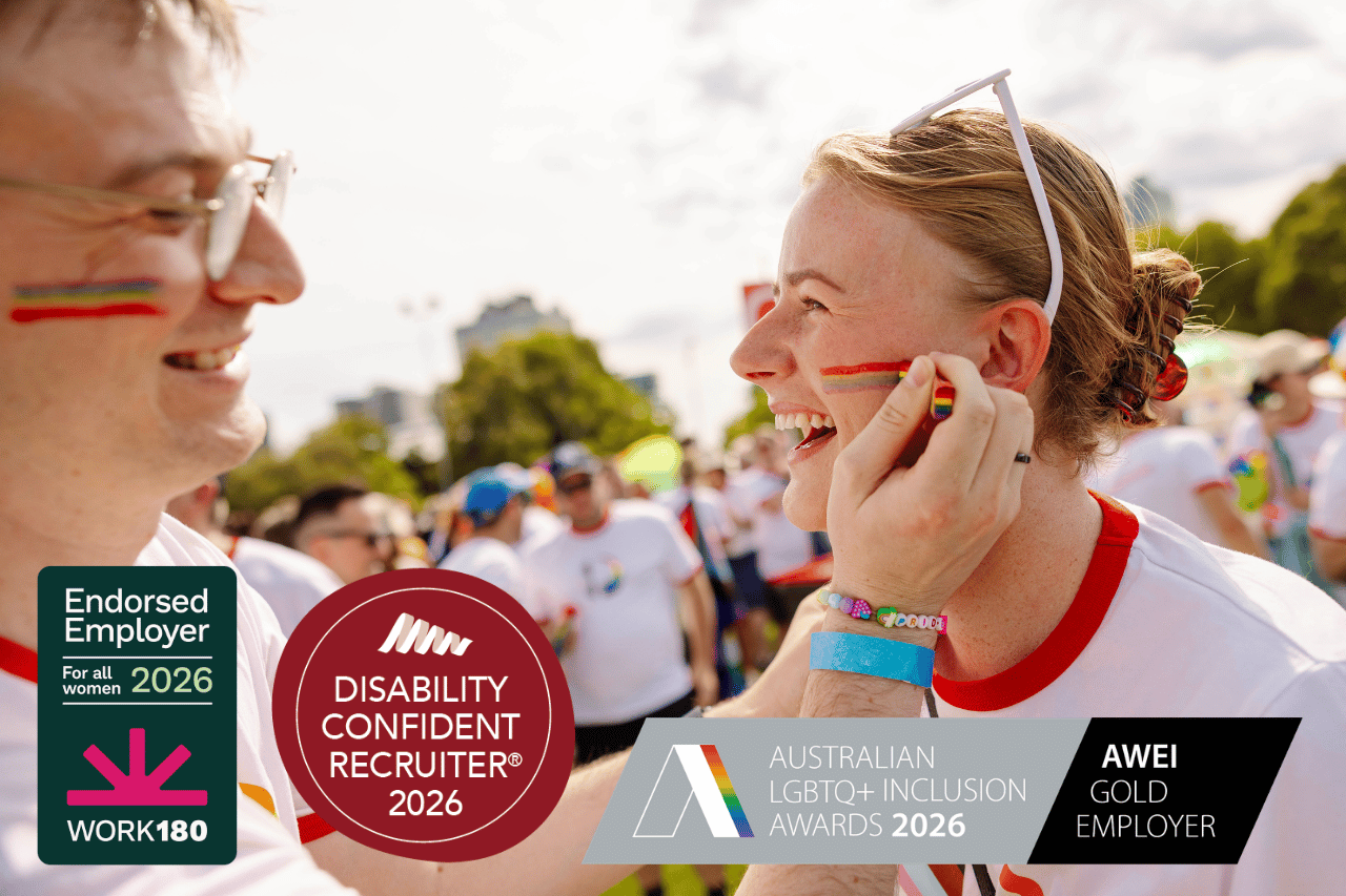 Team member with rainbow face paint helping another team member put on rainbow face paint at Pride March. Overlayed images read ‘Disability confident recruiter 2025’, ‘Australian LGBTQ Inclusion Awards 2025’ and Endorsed Employer Work180 2026